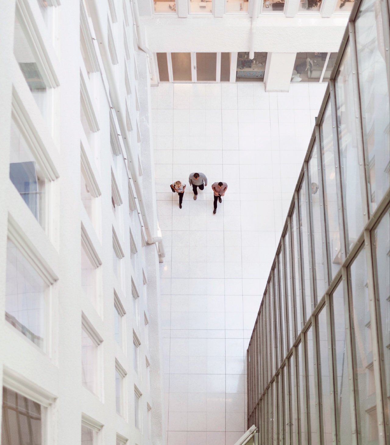 Overhead photo of three people walking through an office park